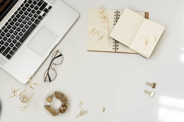 istock Modern home office desk workspace with laptop, notebook, yellow pumpkin, glasses on white background. 1171595511