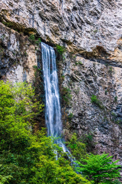 istock Waterfall exit from narrow cave in Zhangjiajie, Grand Canyon 1171598036