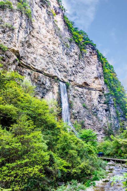 istock Waterfall exit from narrow cave in Zhangjiajie, Grand Canyon 1171598037
