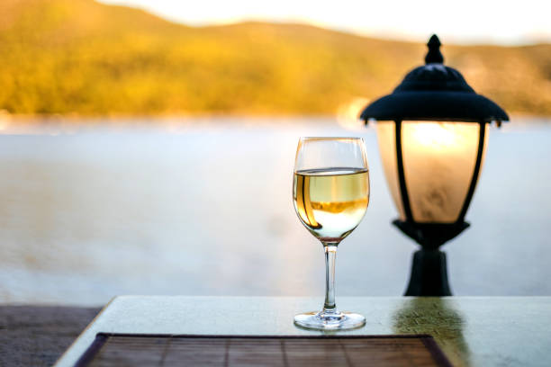Wine glass table setting in a summer restaurant with sea view