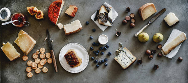 istock Variety of snacks and cheeses over grey background, wide composition 1171608960
