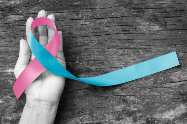 Pink blue ribbon awareness (isolated with clipping path) bow color for newborn birth defect, Sudden Infant Death Syndrome (SIDS), pregnancy Loss on helping hand Pink blue ribbon awareness (isolated with clipping path) bow color for newborn birth defect, Sudden Infant Death Syndrome (SIDS), pregnancy Loss on helping hand miscarriage stock pictures, royalty-free photos & images