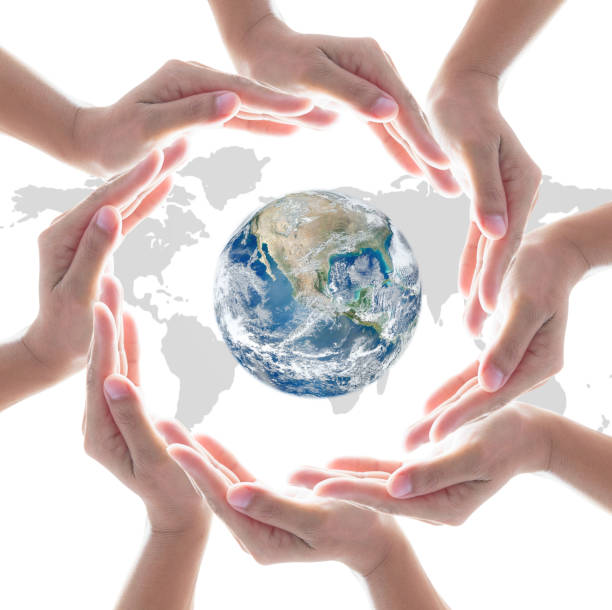 istock Collaborative people's hands surrounding globe world map for community empowerment concept. Elements of this image furnished by NASA 1171612565