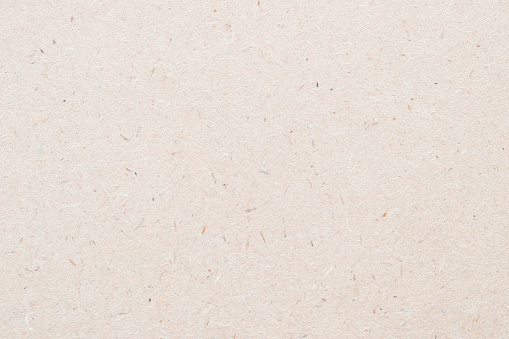 Tablero de partículas, fondo de aglomeca con textura granulada de prensas de partículas panel de madera u OSB Tablero de hilo orientado en color crema marrón beige claro sepia photo