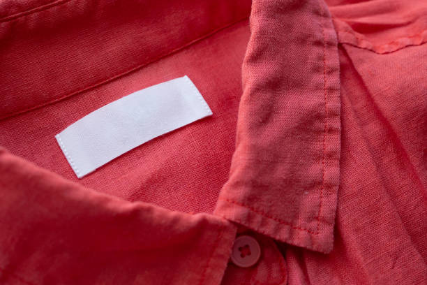 istock White blank clothing tag label on red linen shirt fabric texture background 1171612579