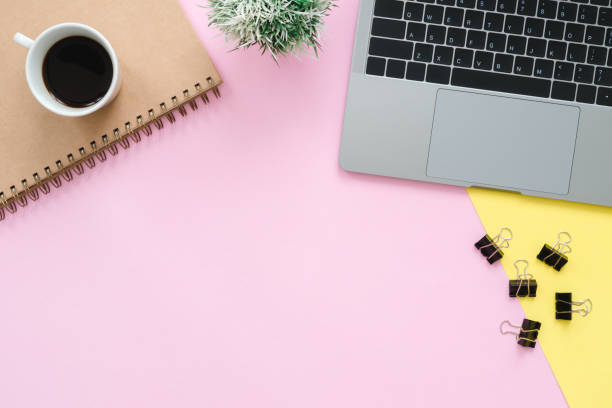 istock Creative flat lay photo of workspace desk. Top view office desk with laptop, blank empty notebooks and coffee cup on pastel color background. Top view with copy space, flat lay photography. 1171612763