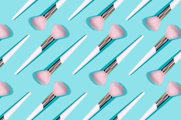 istock Pattern made of make up white brush on turquoise background. 1171613213