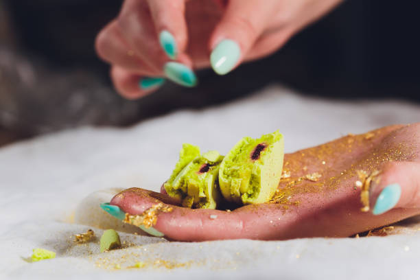 istock Broken macaroons in female hand. On a white background. 1171613902