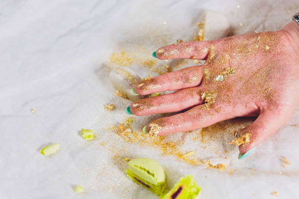 istock Broken macaroons in female hand. On a white background. 1171613909