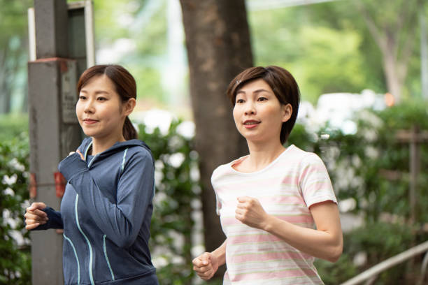 istock Two women running in city 1171620512