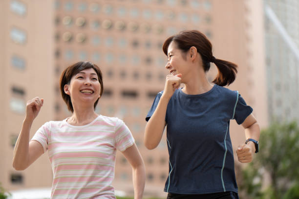 istock Two women running in city 1171621579