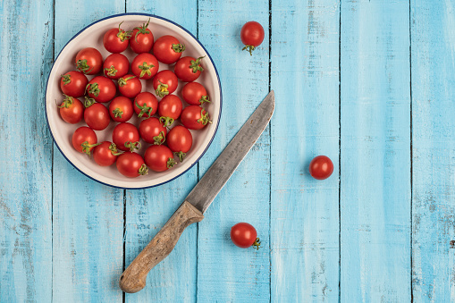 ripe cherry tomatoes on a wooden table with copy space