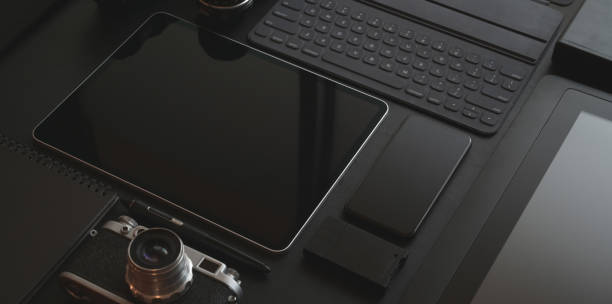 istock Black stylish workplace with tablet, smartphone, camera and office supplies 1171623993