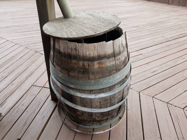 istock worn wood barrel with metal rings on deck 1171624858