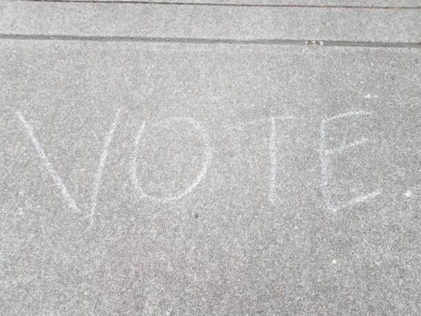 istock vote sign drawn on grey asphalt or pavement 1171626225
