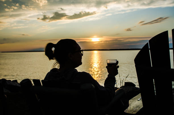 istock Woman drinking wine in front of river 1171627435