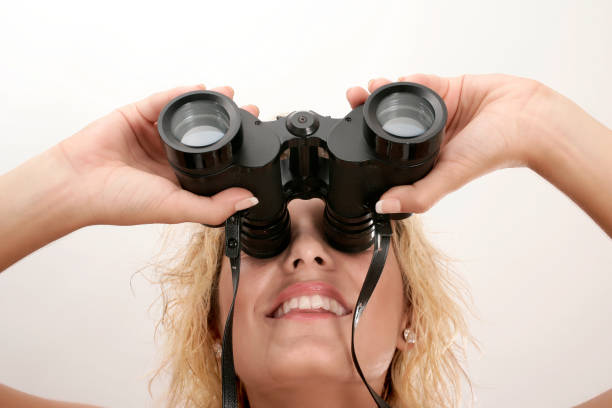 istock young adult woman looking through binoculars 1171631121