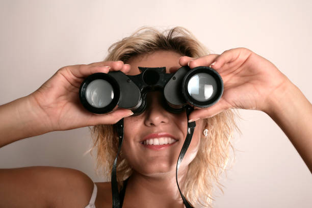 istock young adult woman looking through binoculars 1171631301