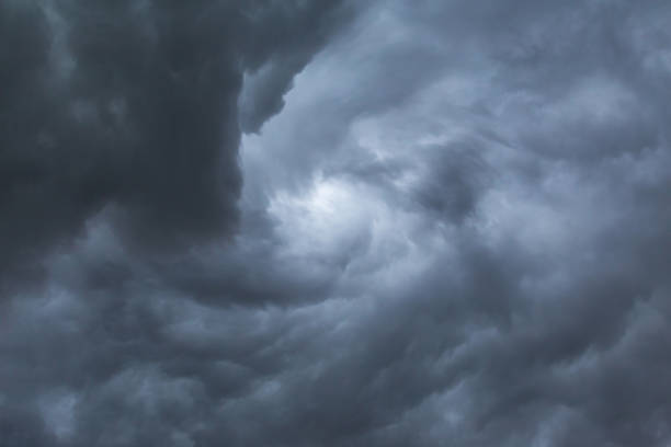 istock Dark storm clouds before rain. Blurred swirl in the dark storm clouds 1171636764