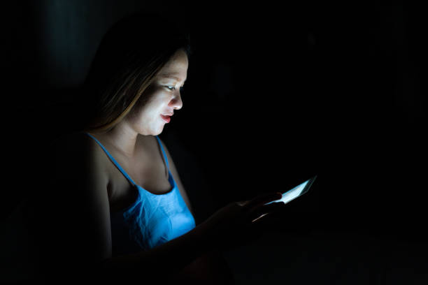 istock Woman using tablet in the dark room 1171638715