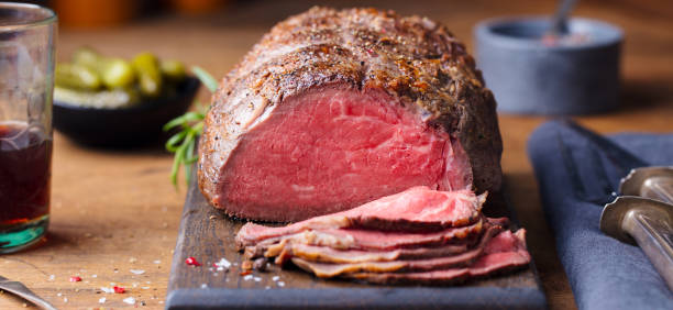 istock Roast beef on cutting board. Wooden background. Close up. 1171641456