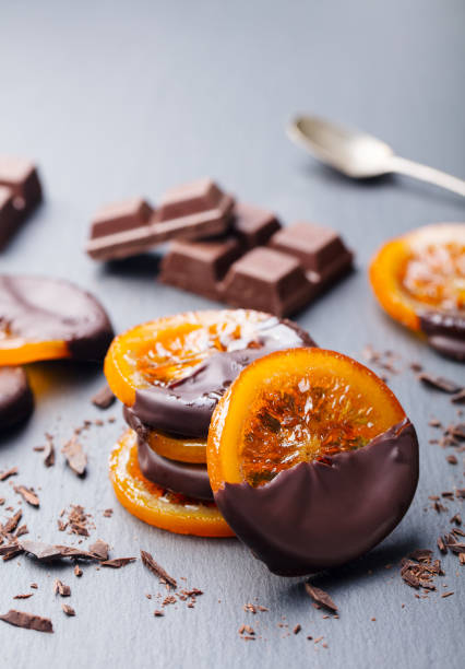 Candied orange slices in chocolate. Slate background. Copy space. Candied orange slices in chocolate. Slate background. Copy space candied fruit stock pictures, royalty-free photos & images
