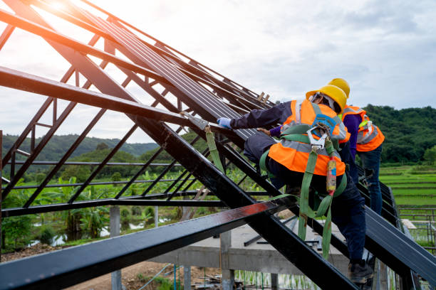 Roofer worker in protective uniform wear and gloves Construction worker wearing safety harness using secondary safety device connecting into 15 mm static rope using as fall restraint shingle on top of the new roof. unsafe workplace stock pictures, royalty-free photos & images
