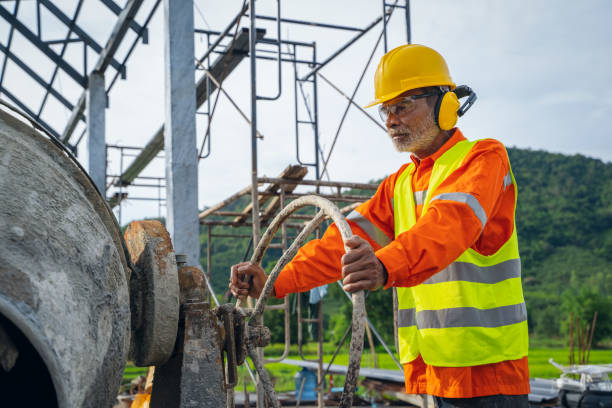 istock Construction workers wearing safety clothing worker On Building Site Mixing Cement 1171642465