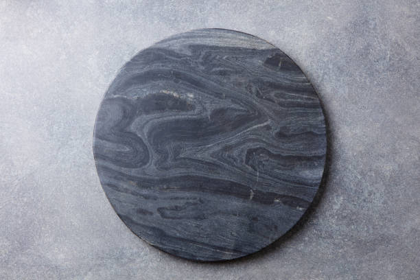 Black marble texture board on grey background. Top view. Copy space. stock photo