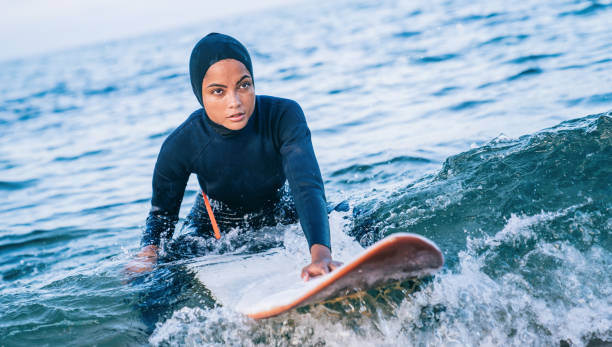 istock Female surfer with hijab in sea 1171643685