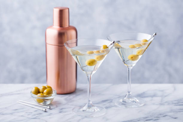 istock Martini cocktail with green olives, shaker on marble table background. 1171644790