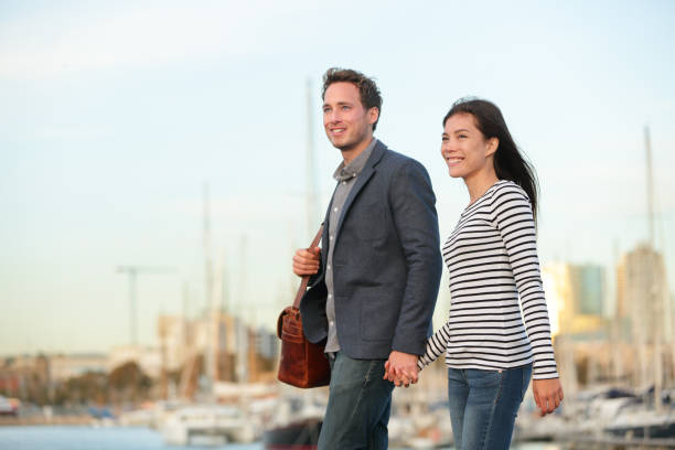 istock Young couple walking outdoors in city harbor 1171646503
