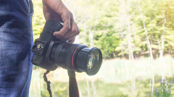istock Professional photographer holding dslr camera in nature. 1171648996