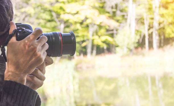 istock Professional photographer taking picture in nature. 1171648997