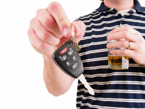 a man handing over his keys while drinking a beer.
