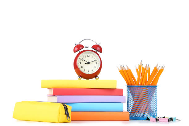 istock School supplies with red alarm clock on white background 1171650404
