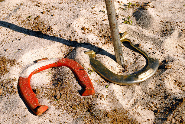 Real ringer game of horseshoes Horseshoe making a ringer around the peg. ringer stock pictures, royalty-free photos & images