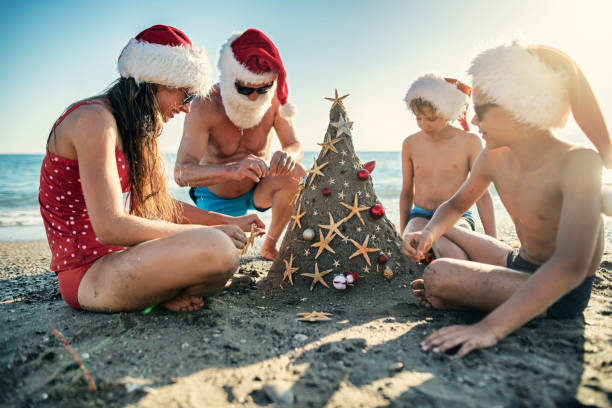istock Family decorating sand Christmas tree on summer Christmas 1171652490
