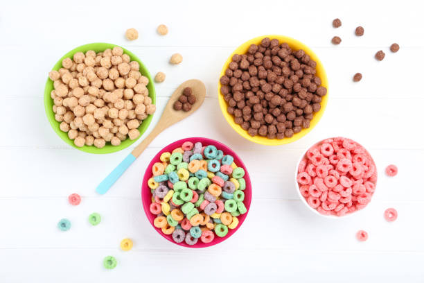 istock Various corn flakes in bowls with spoon on white wooden table 1171652588