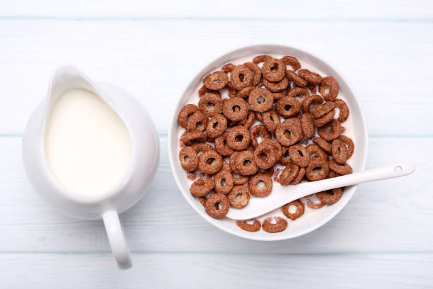 istock Chocolate corn flakes in bowl with milk and spoon on wooden table 1171652652