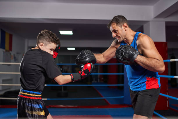 istock Kickboxer kid and his coach 1171653454
