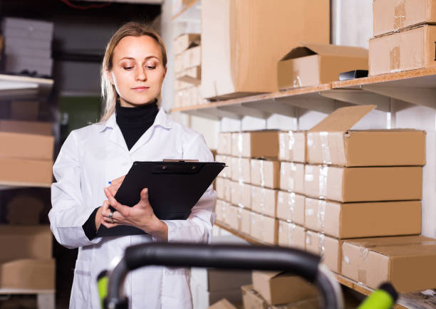 istock female worker transporting cart cardboard  cases in storage 1171653498