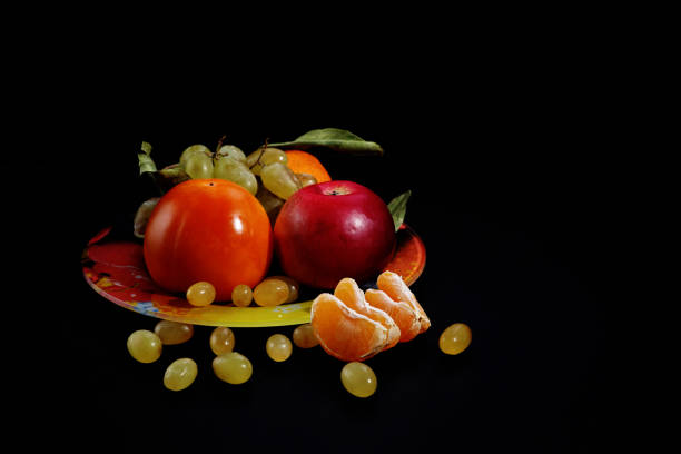 istock Still life with fruit on a black background, space for text 1171653646