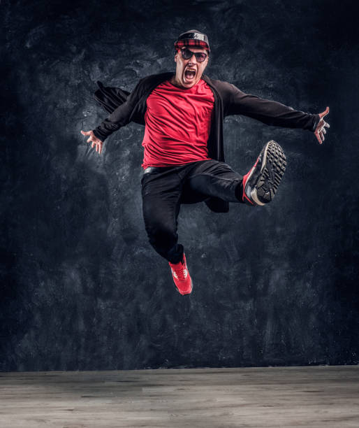istock Emotional stylish dressed guy performing break dance jumping. 1171654899
