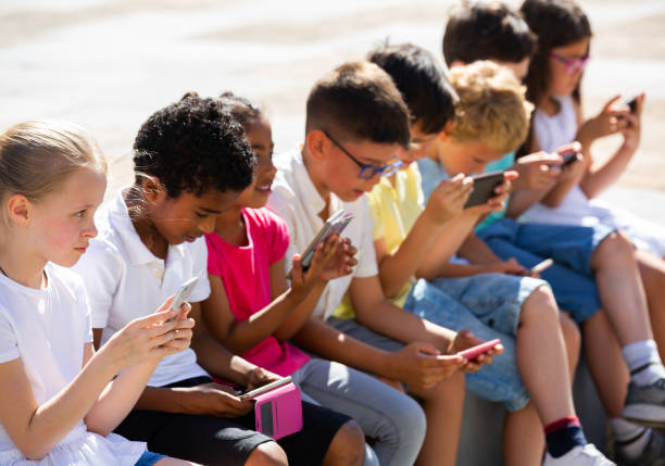 istock Children are playing on smartphone in the playground 1171655811