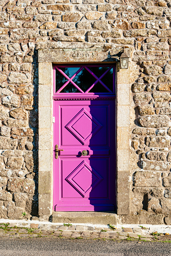 Old Purple closed door in stone wall. Retro style