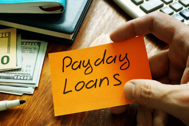 istock Payday loans written on a piece of paper. 1171659781