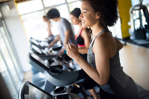 istock Beautiful fit people exercising together in gym 1171659791