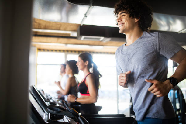 istock Group of sportive people in a gym training 1171659822