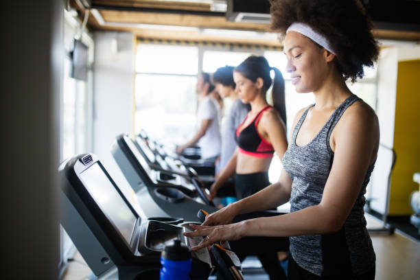 istock Group of sportive people in a gym training 1171659911